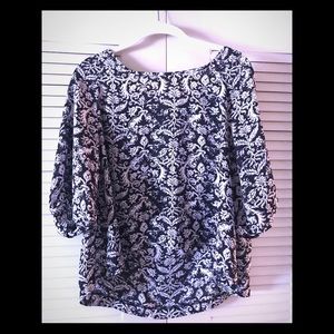 “About a girl” black and white patterned blouse.